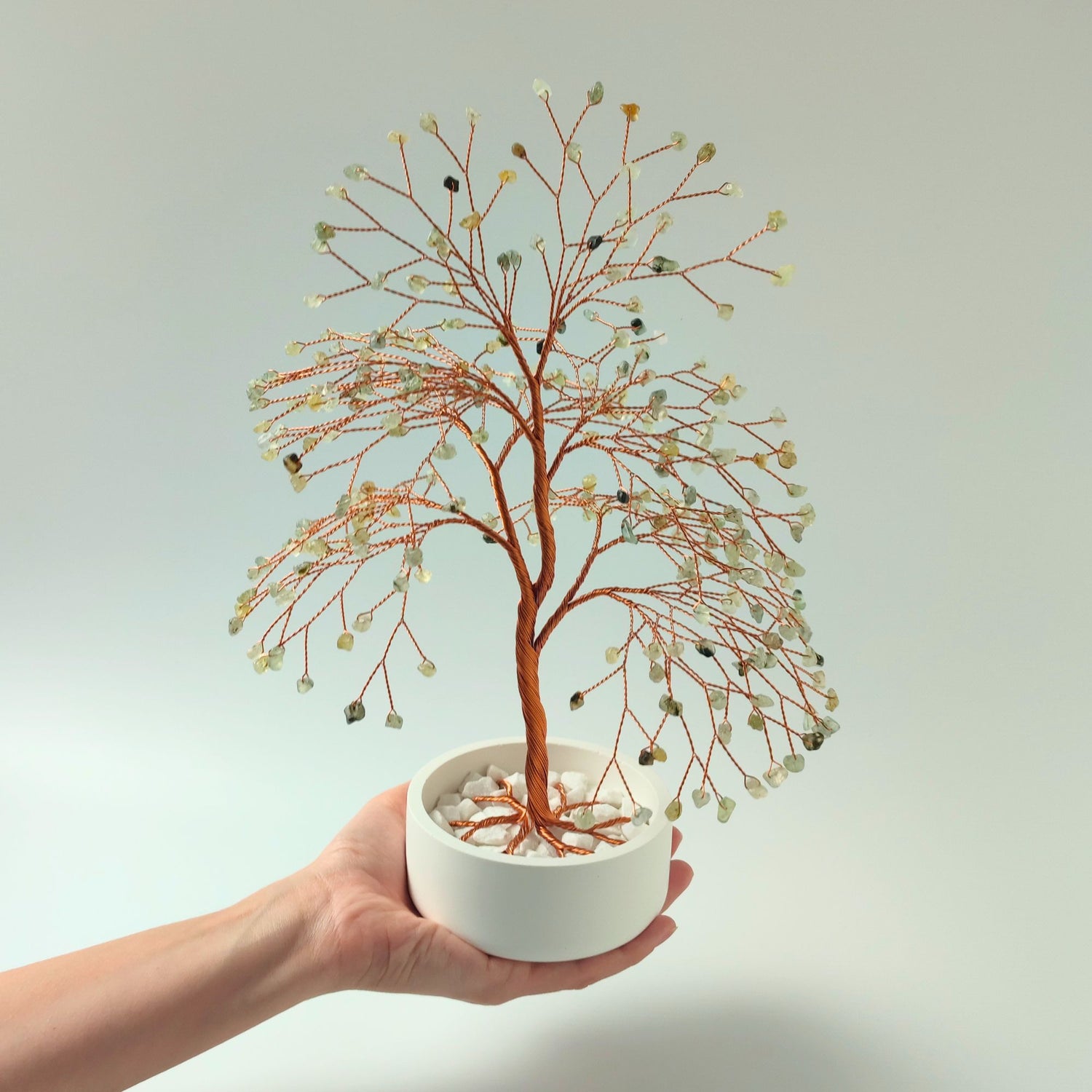 Prehnite gemstone copper large tree with decorative stones shown in hand to show size and proportion