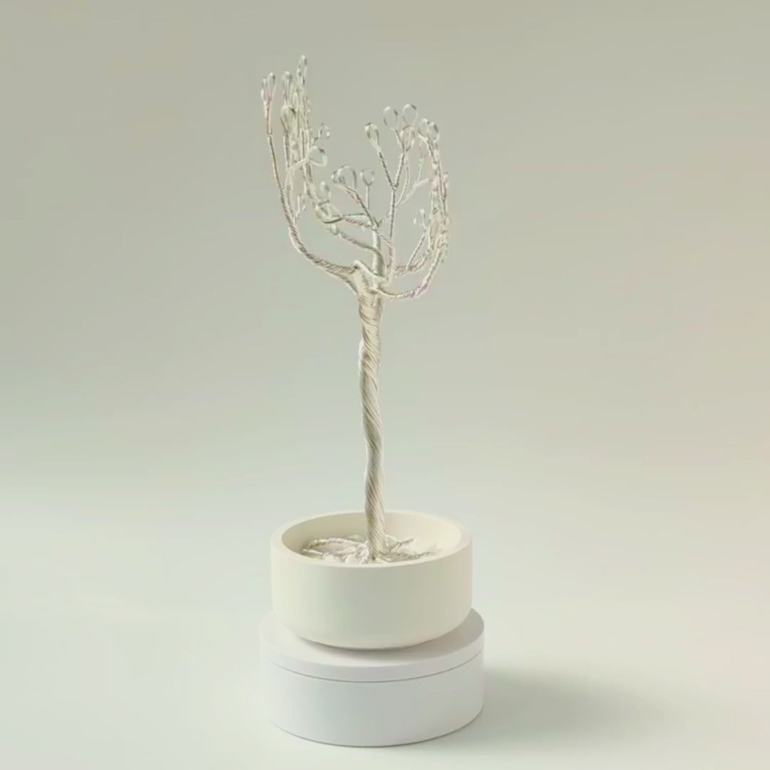 360° video of handmade silver jewelry tree with ceramic bowl and decorative white stones