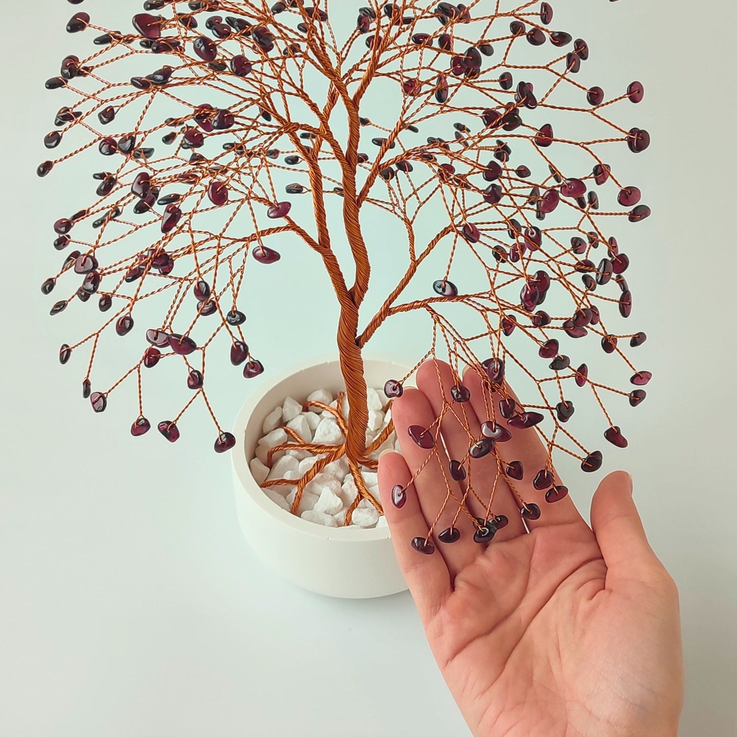 280 of garnet gemstones compared with hand to show size and proportion