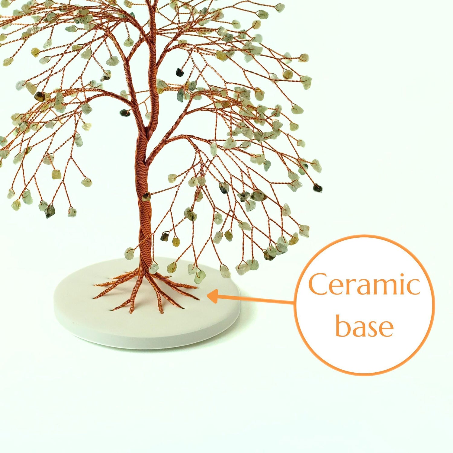 Decorative tree with ceramic base on a white background