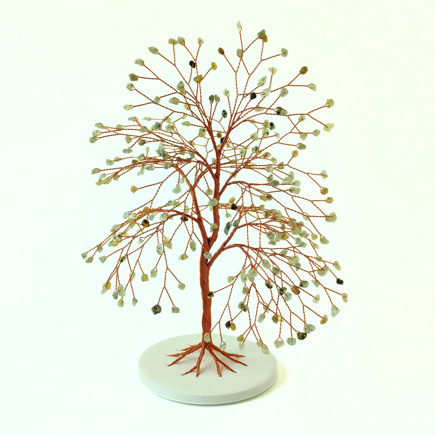 Decorative tree sculpture with branches and prehnite on a white background