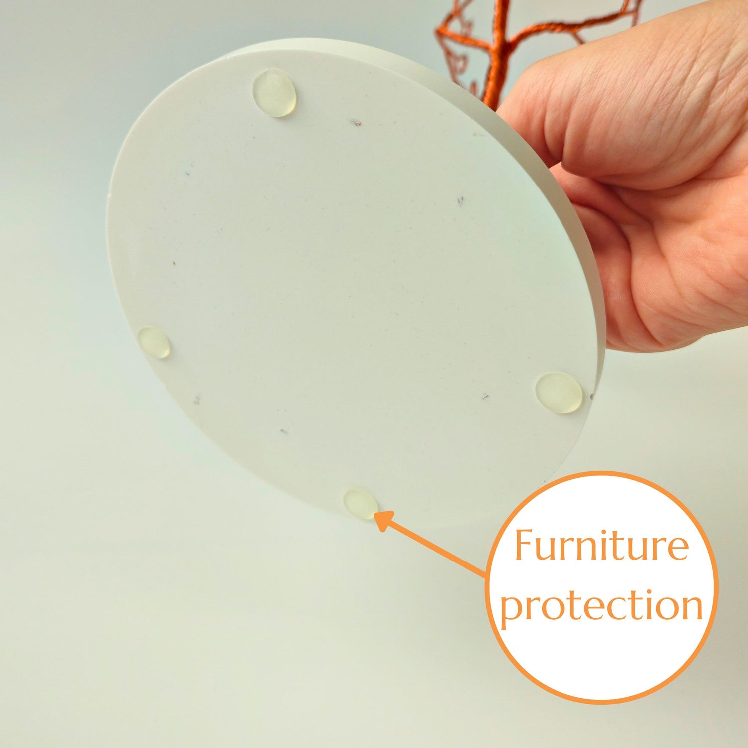 Copper wire jewelry tree with white ceramic tray base and silicone furniture protection