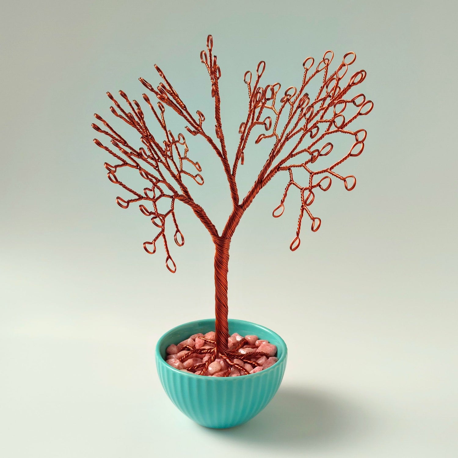 Handmade copper wire jewelry tree in turquoise ceramic bowl
