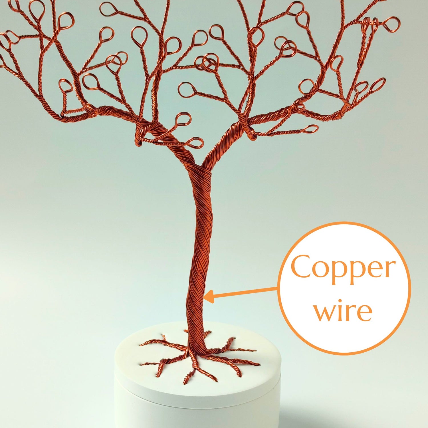 Close-up of copper wire jewelry stand trunk with material annotation