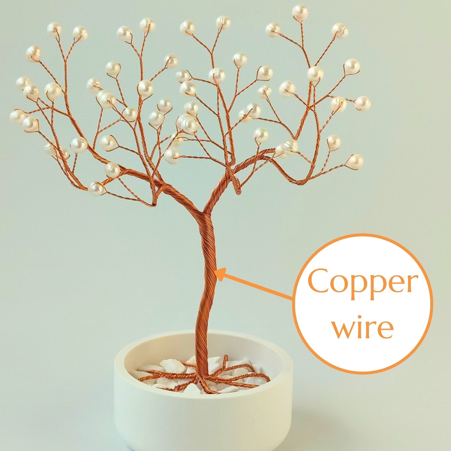 Strong copper wire trunk of handmade pearl jewelry elegant tree – close-up detail