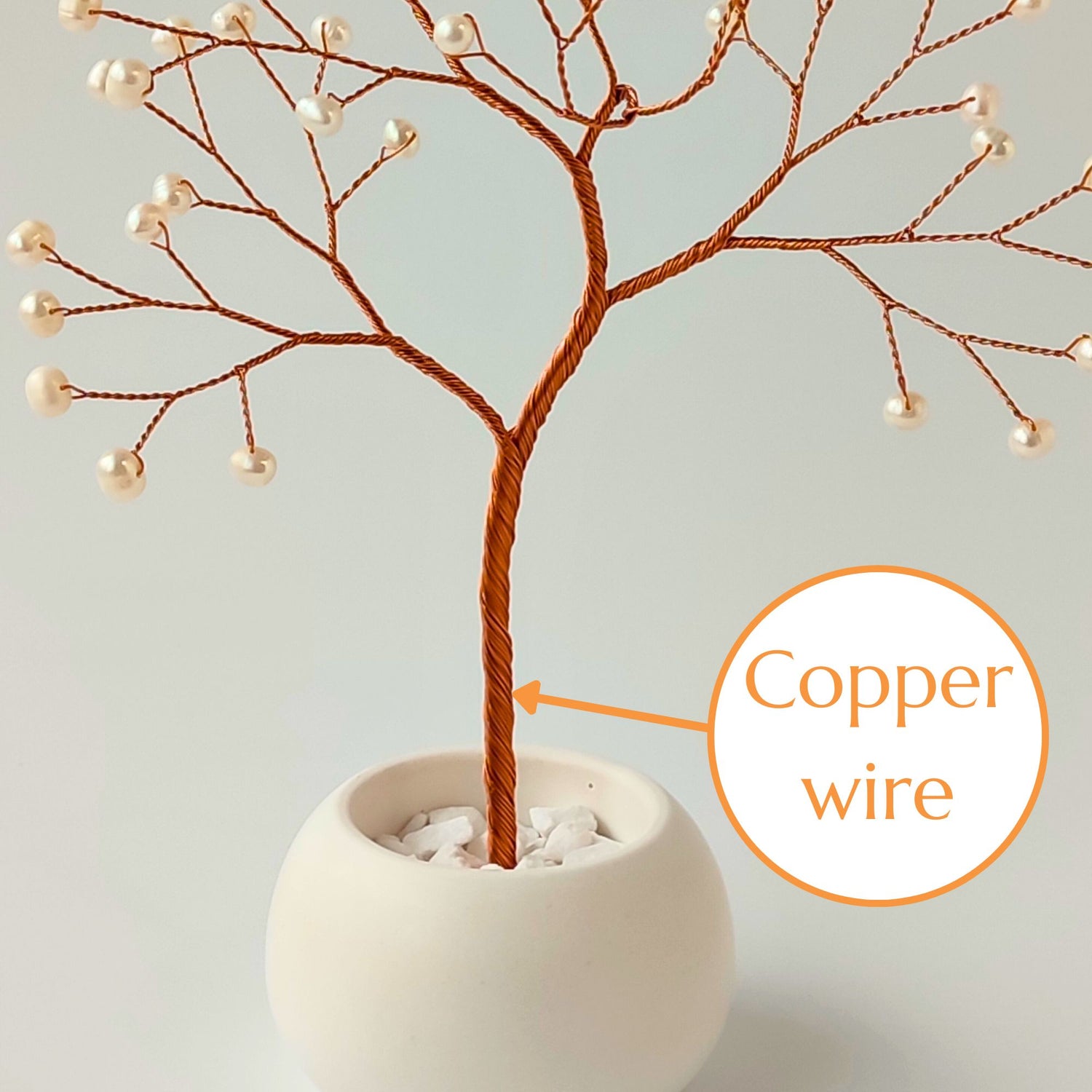 Strong copper wire trunk of handmade pearl jewelry tree – close-up detail