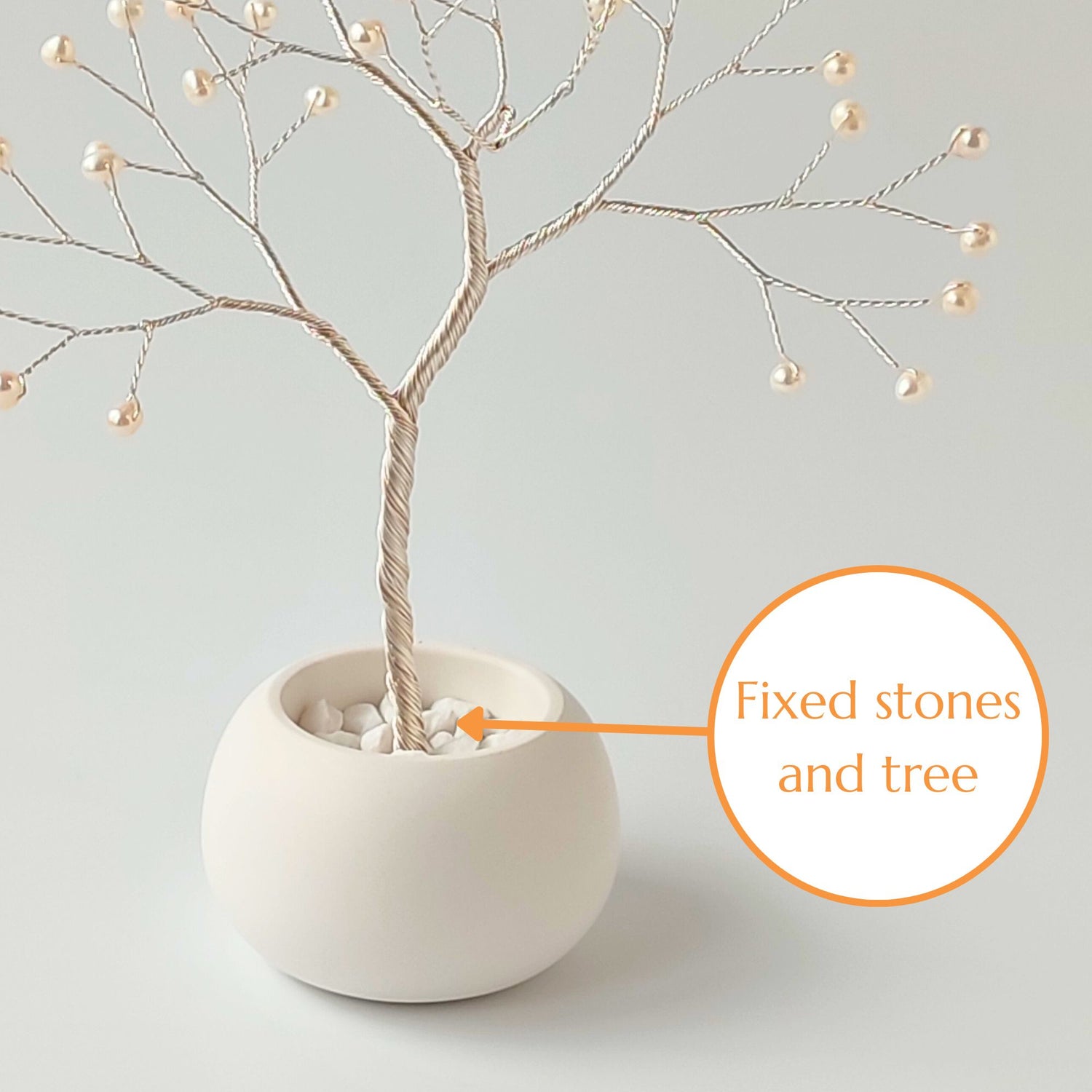 Fixed decorative stones and silver roots inside the ceramic bowl – secure base of pearl small tree