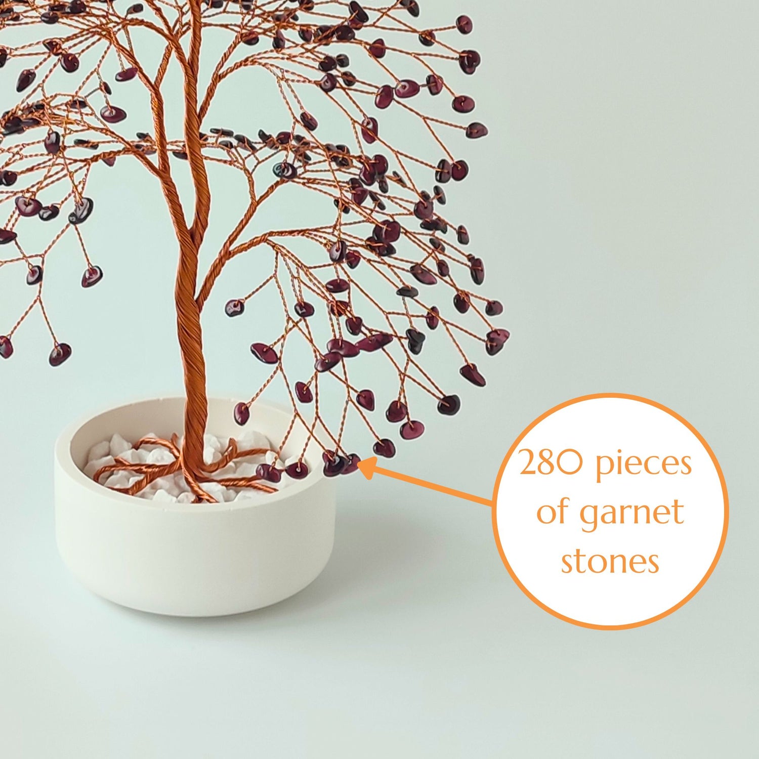 Close-up of copper wire branch with 280 natural garnet gemstone – elegant detail
