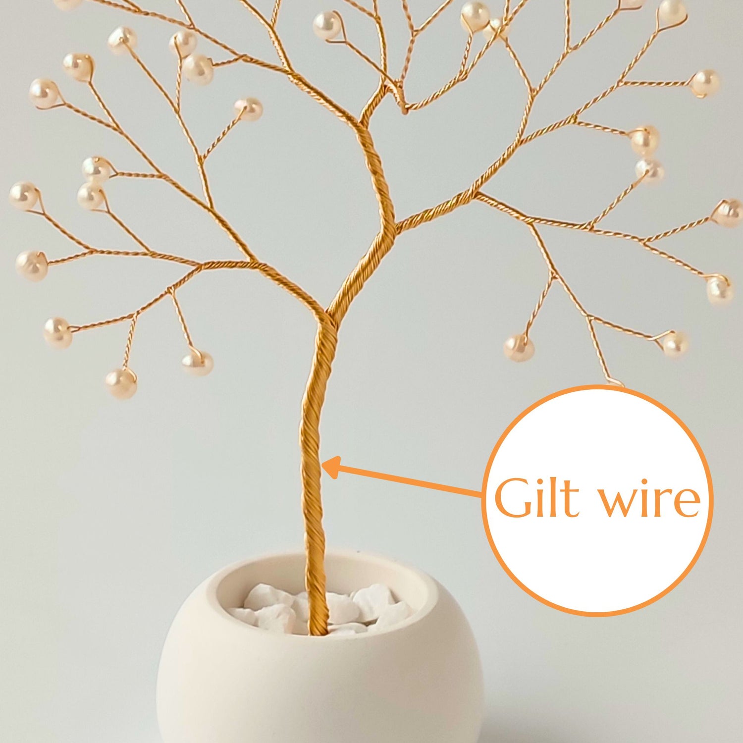 Strong gilt wire trunk of handmade pearl jewelry small tree – close-up detail