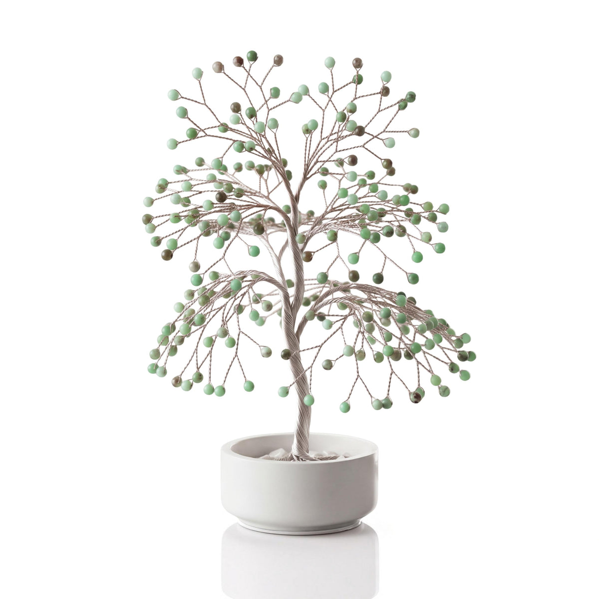 Silver-plated wire tree with polished mint and apple green chrysoprase spheres in a white ceramic bowl