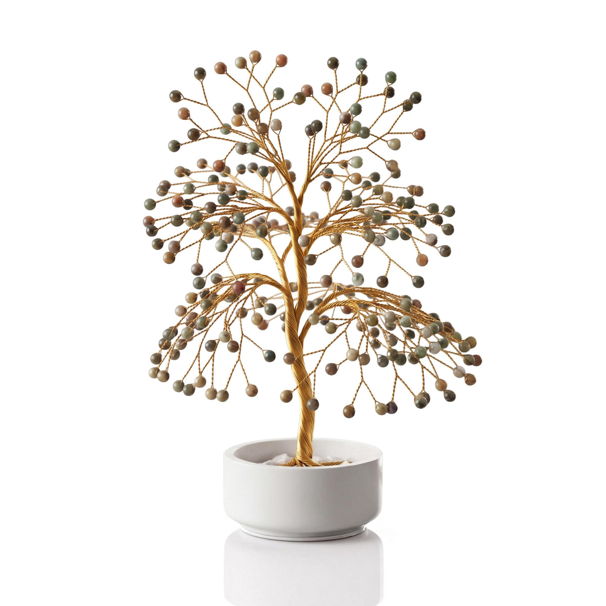 Gold-plated wire tree with polished olive and rust green opal spheres in a white ceramic bowl