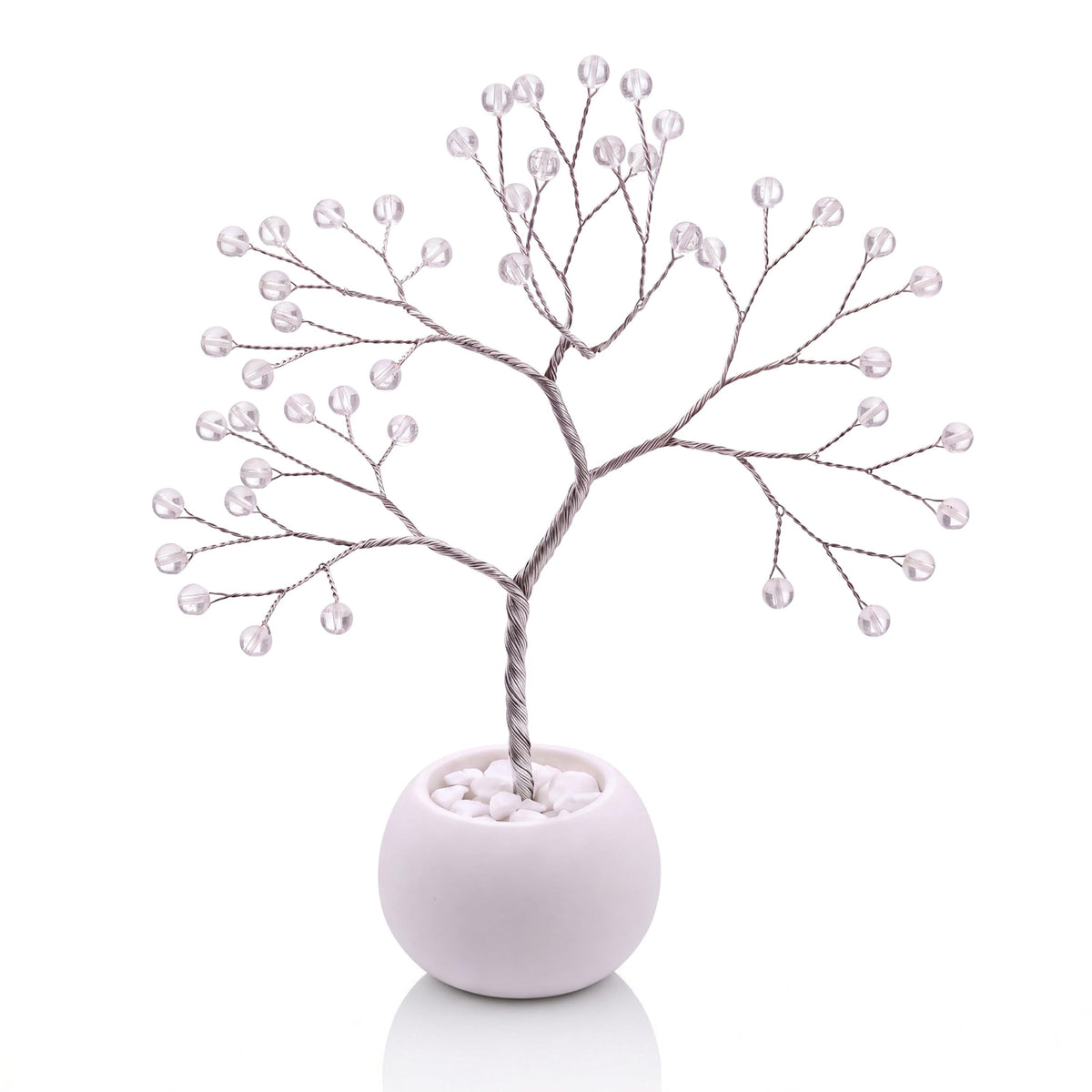 Silver-plated wire tree with polished clear quartz beads in a white bowl with white pebbles