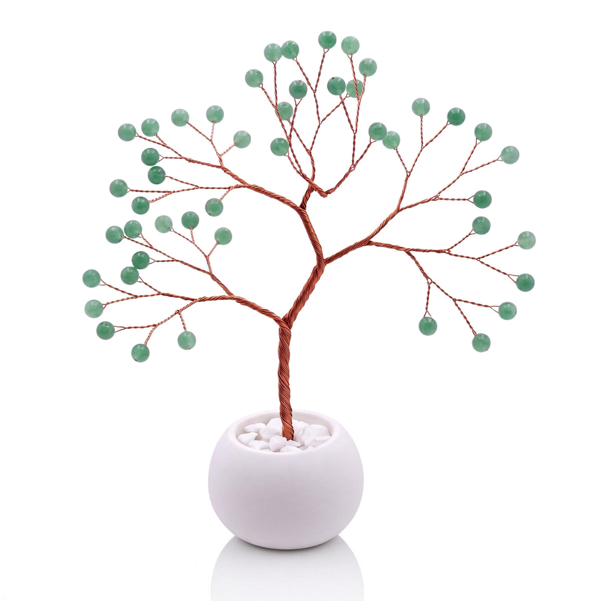 Copper wire tree with polished sage green aventurine beads in a plain white bowl filled with white pebbles