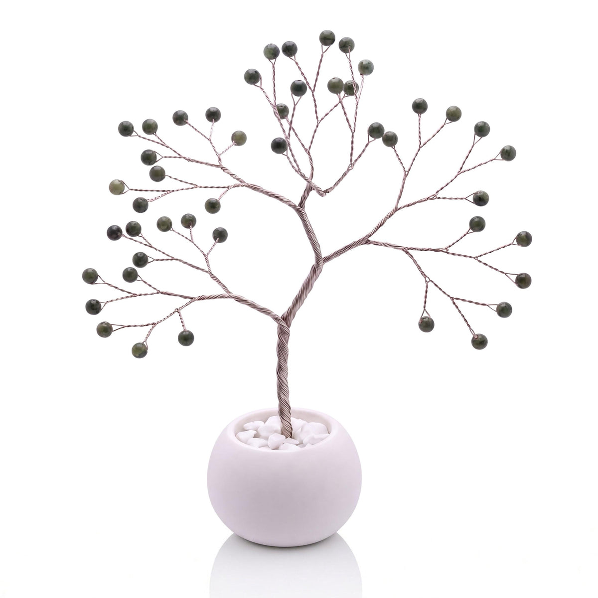 Silver-plated wire tree with polished spinach green nephrite jade beads in a white bowl with white pebbles