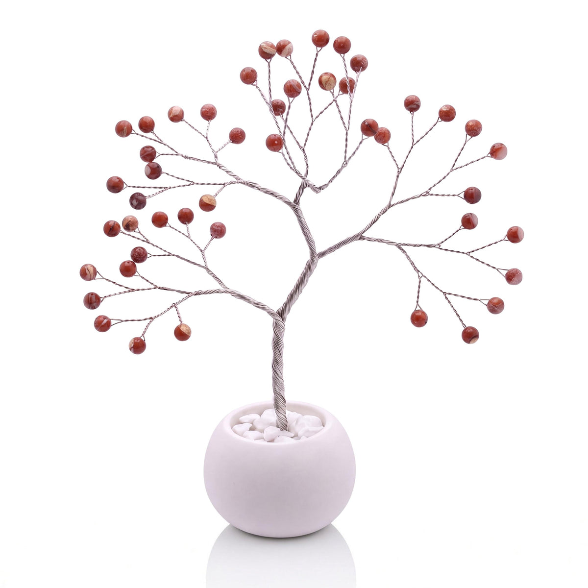 Silver-plated wire tree with polished canyon red jasper beads with white veins in a white bowl with white pebbles