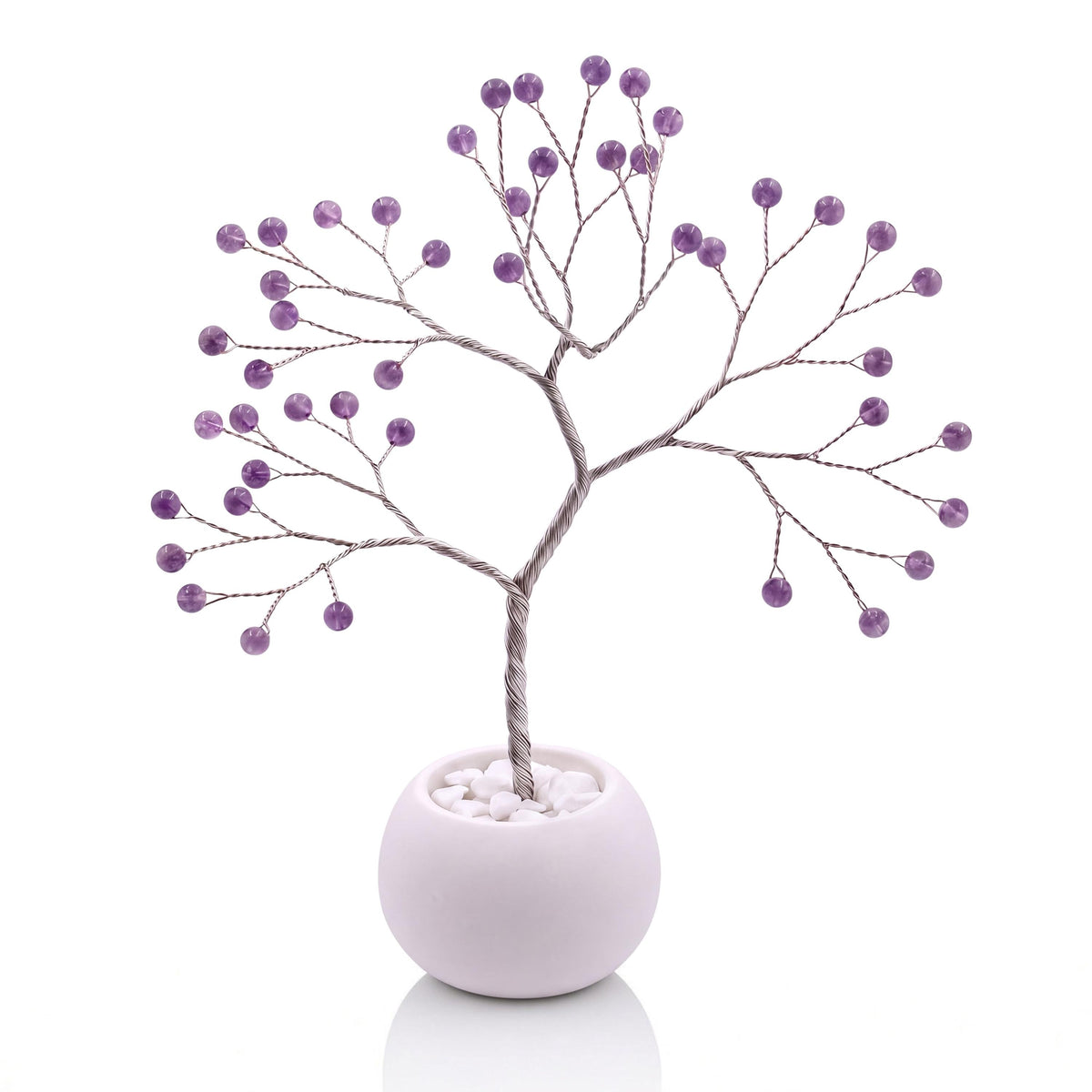 Silver-plated wire tree with polished grape purple amethyst beads in a white bowl with white pebbles