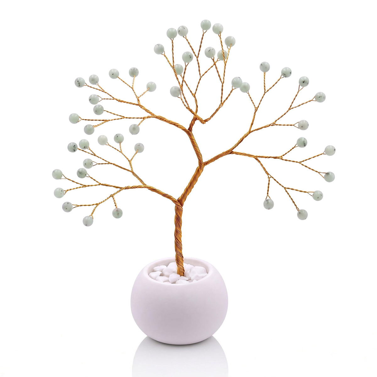 Gold-plated wire tree with polished celadon green hemimorphite beads in a white bowl with white pebbles