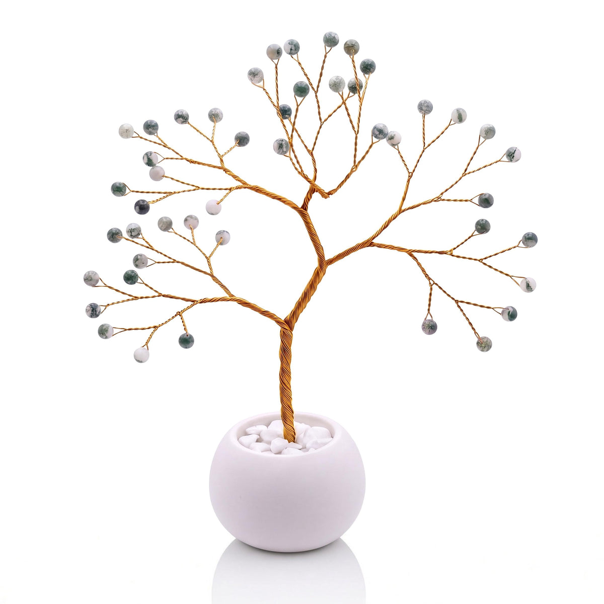Gold-plated wire tree with polished snowy white and fir green tree agate beads in a white bowl with white pebbles