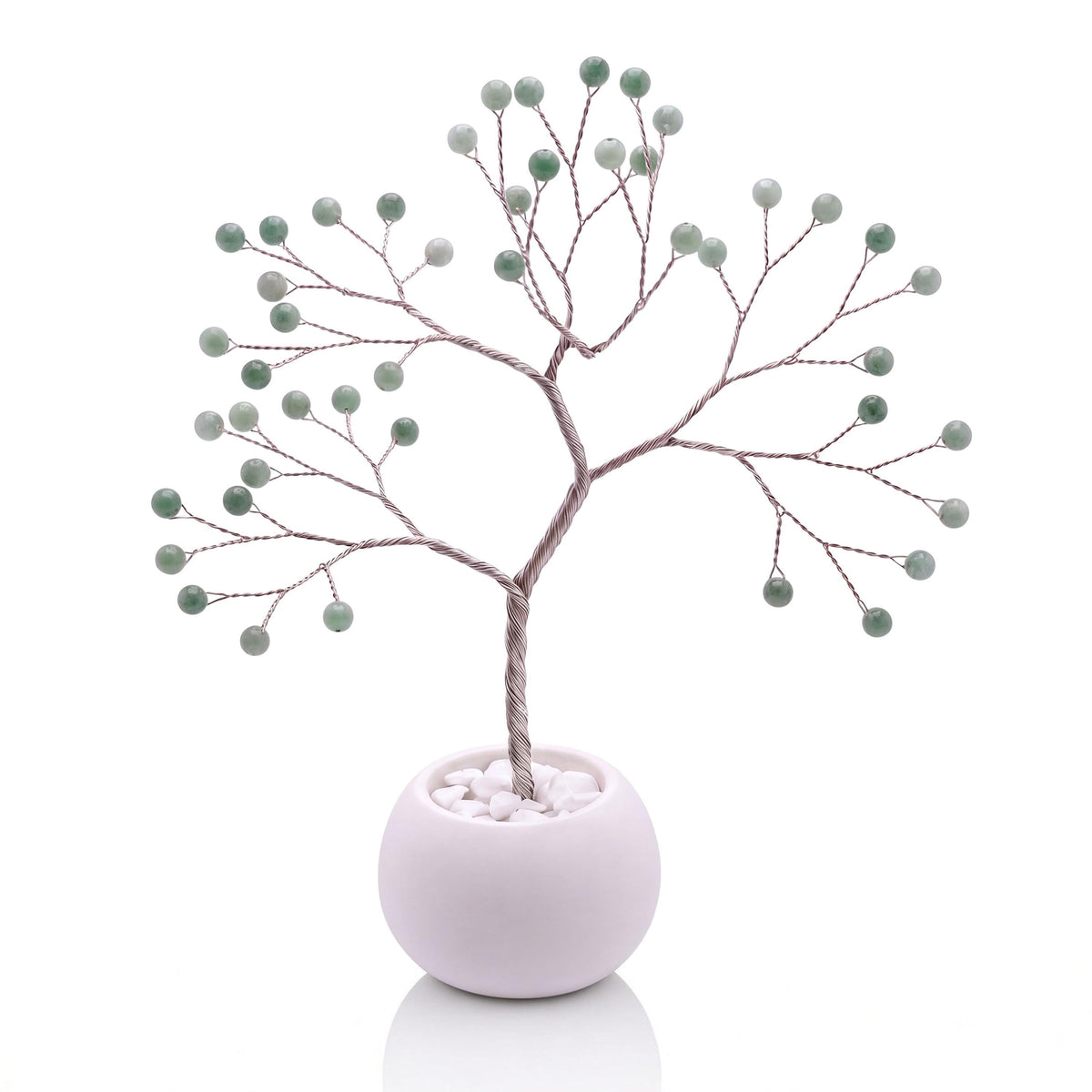 Silver-plated wire tree with polished spring leaf green jadeite beads in a white bowl with white pebbles
