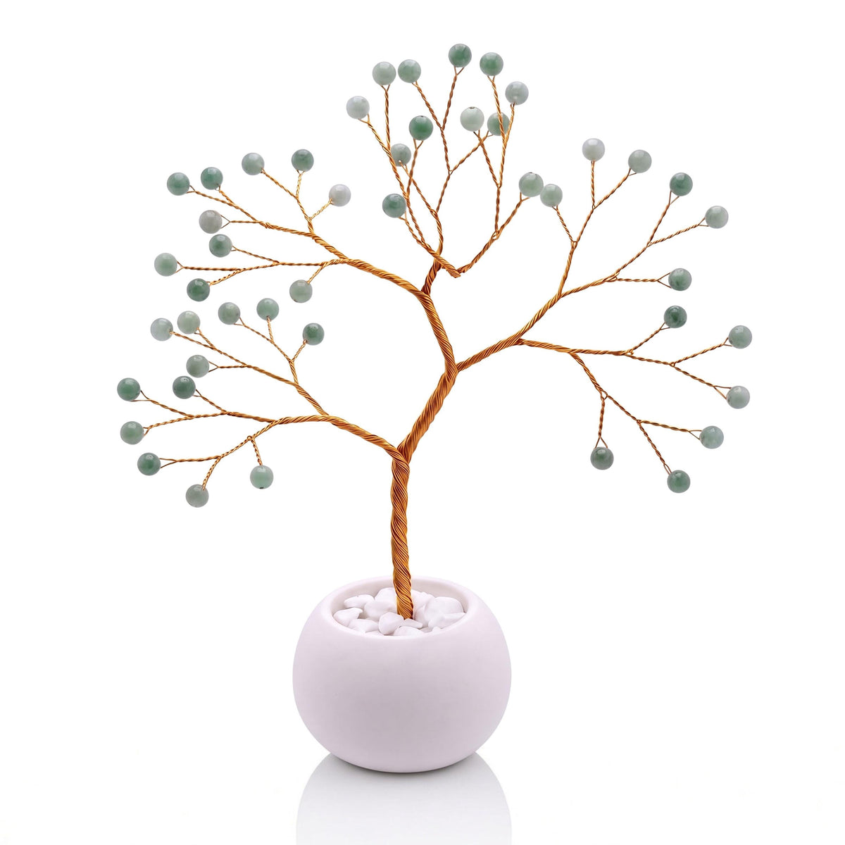 Gold-plated wire tree with polished spring leaf green jadeite beads in a white bowl with white pebbles