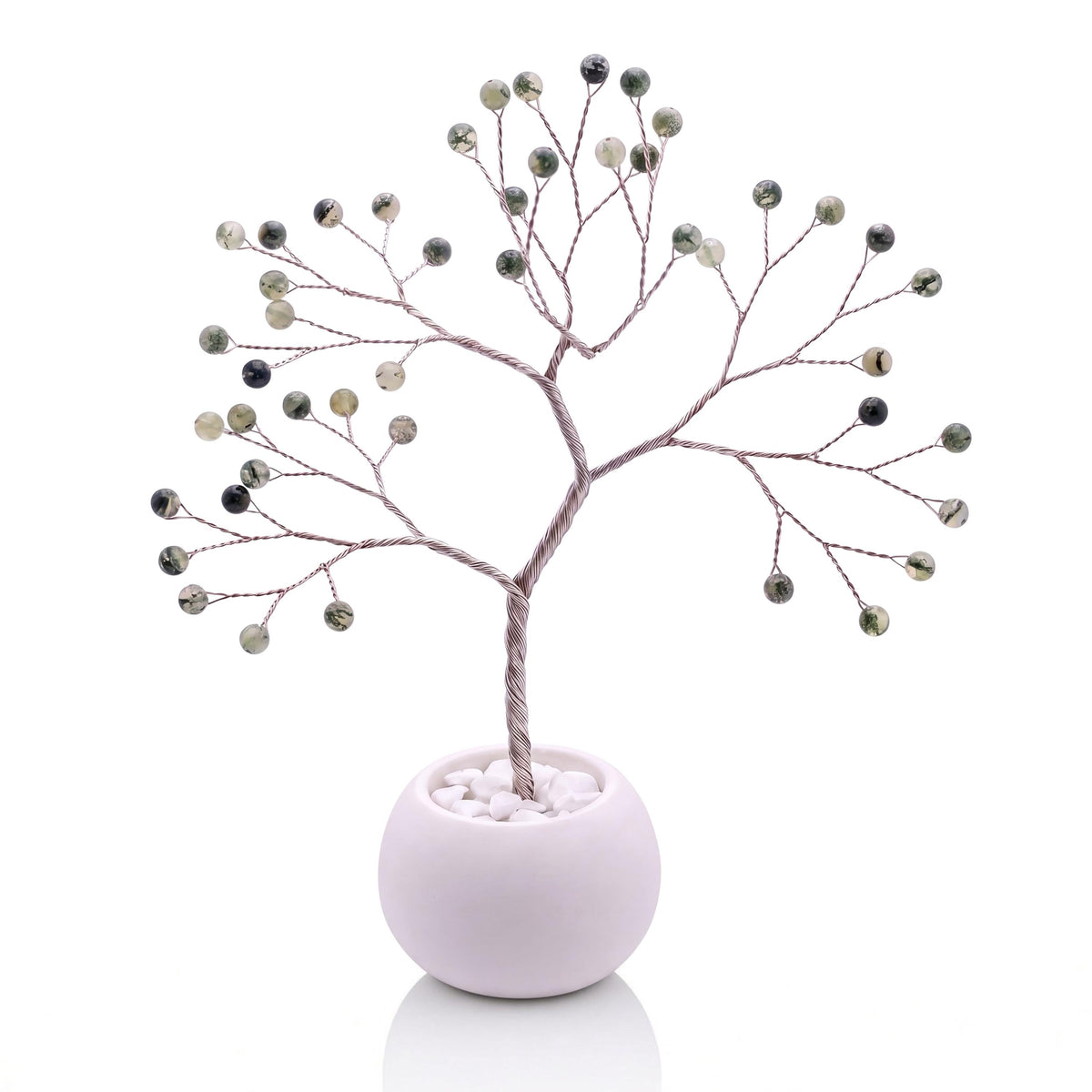 Silver-plated wire tree with polished green prehnite beads in a white bowl with white pebbles