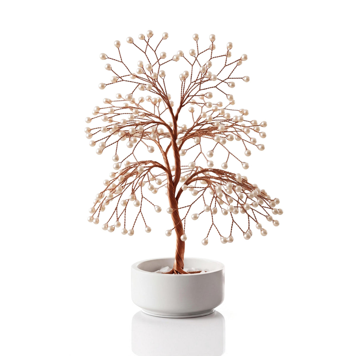Large handmade copper Tree of Life with white freshwater pearls in a plain white ceramic bowl