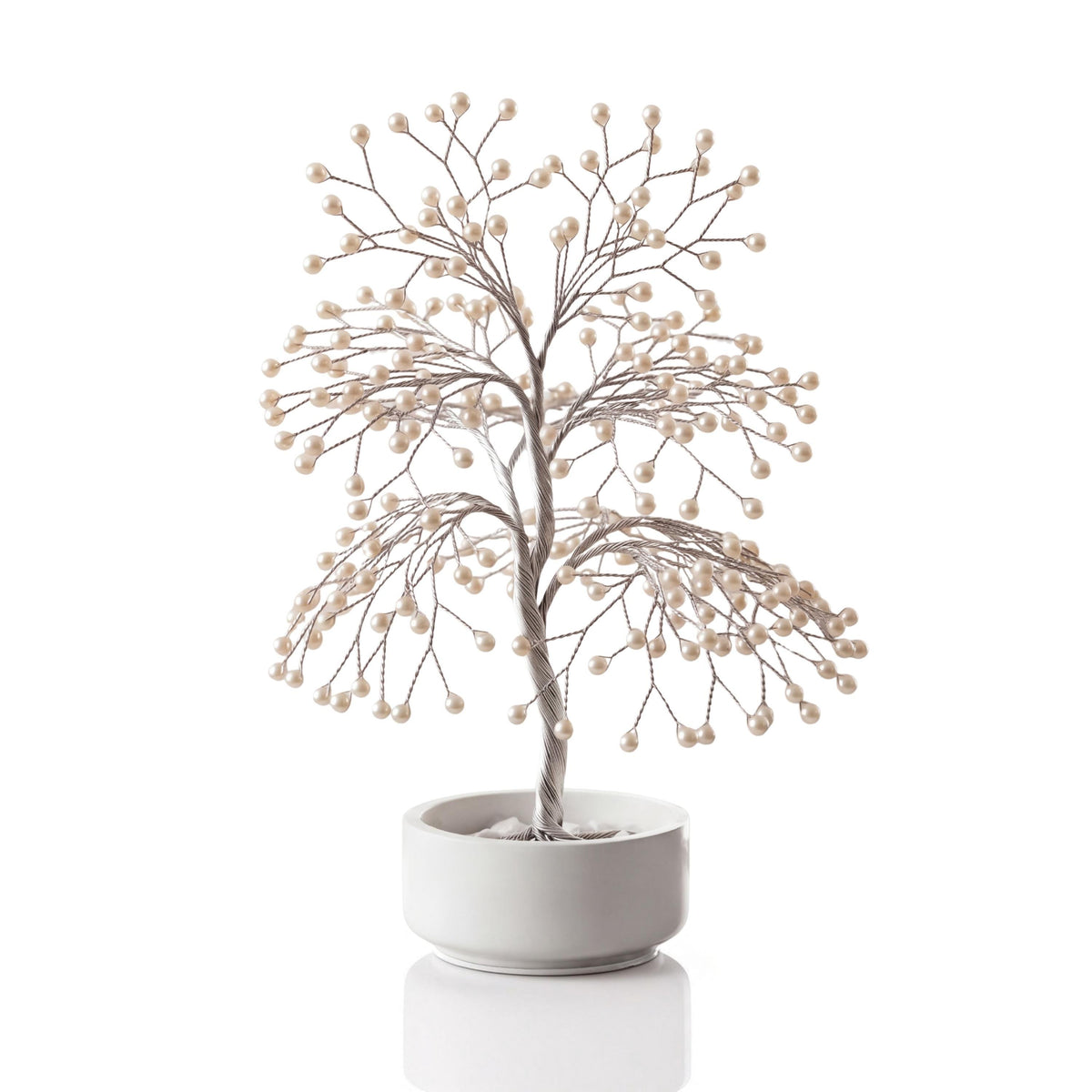 Handmade silver wire pearl tree with white freshwater pearls in a plain white ceramic bowl