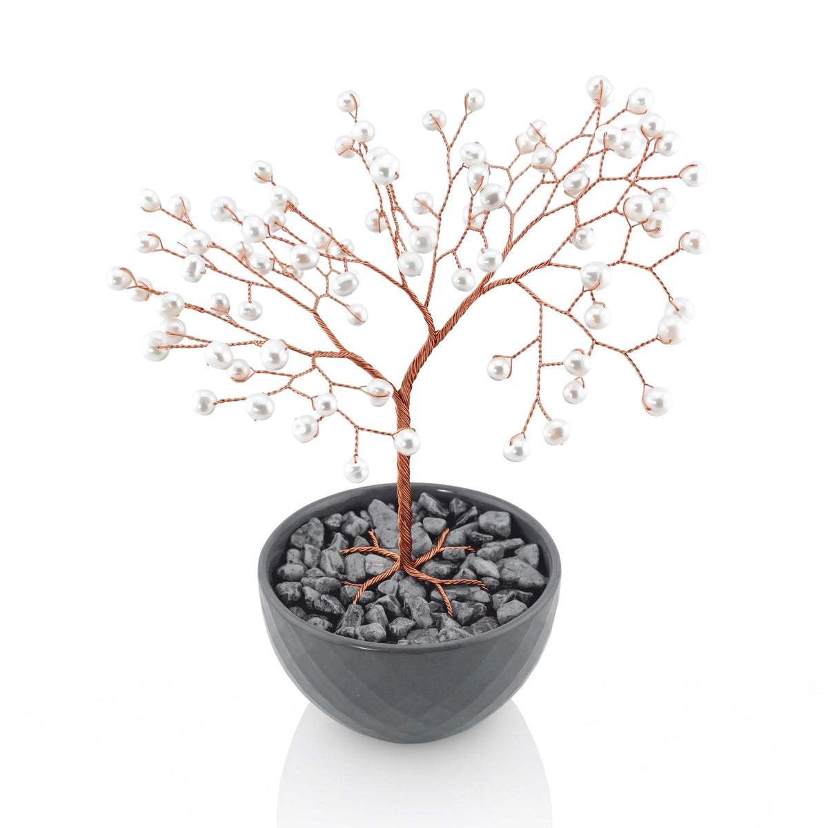 Copper wire tree of life with white freshwater pearls in a grey bowl with grey stones