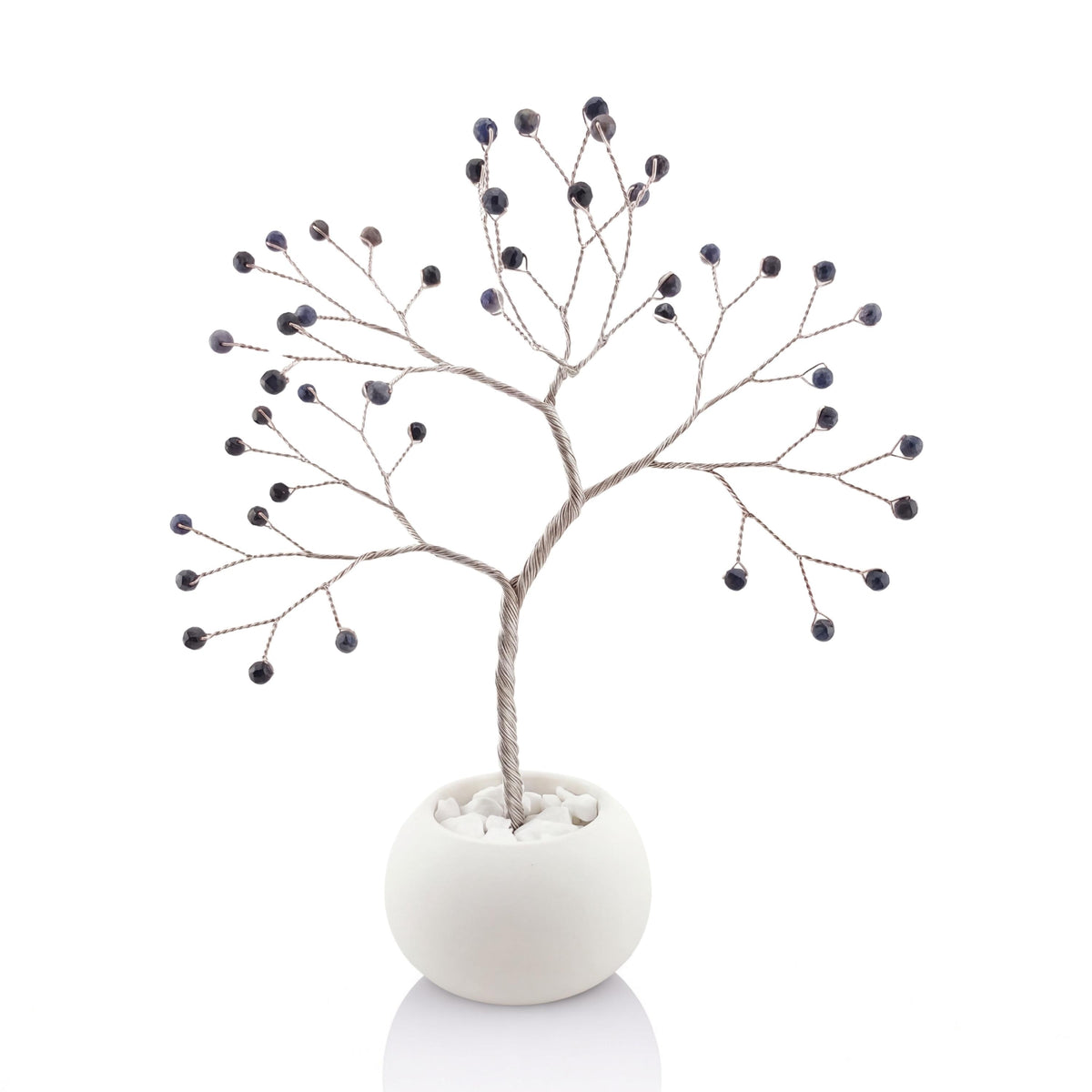 Silver-plated wire tree with dark navy faceted sapphire beads in a white ceramic bowl with printed anniversary text