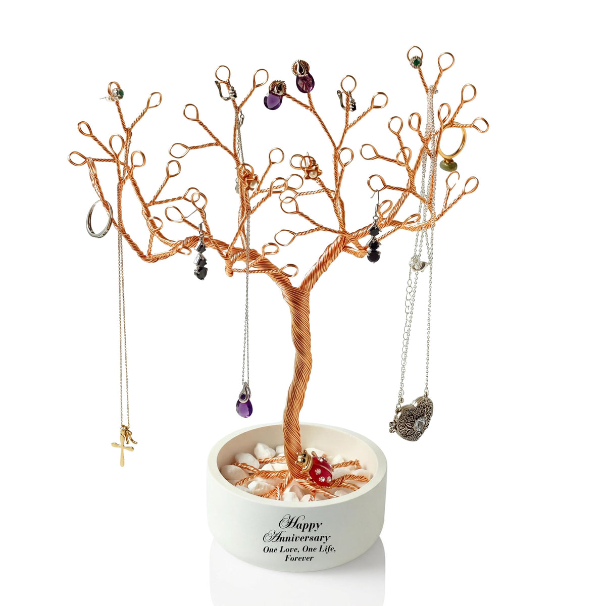 Handmade gold-plated copper wire jewelry tree in a round white ceramic bowl, holding necklaces and charms on its branches