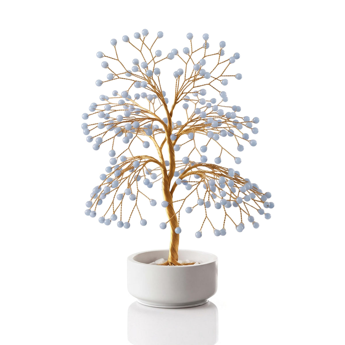 Gold-plated wire tree with polished pale sky blue angelite spheres in a white ceramic bowl