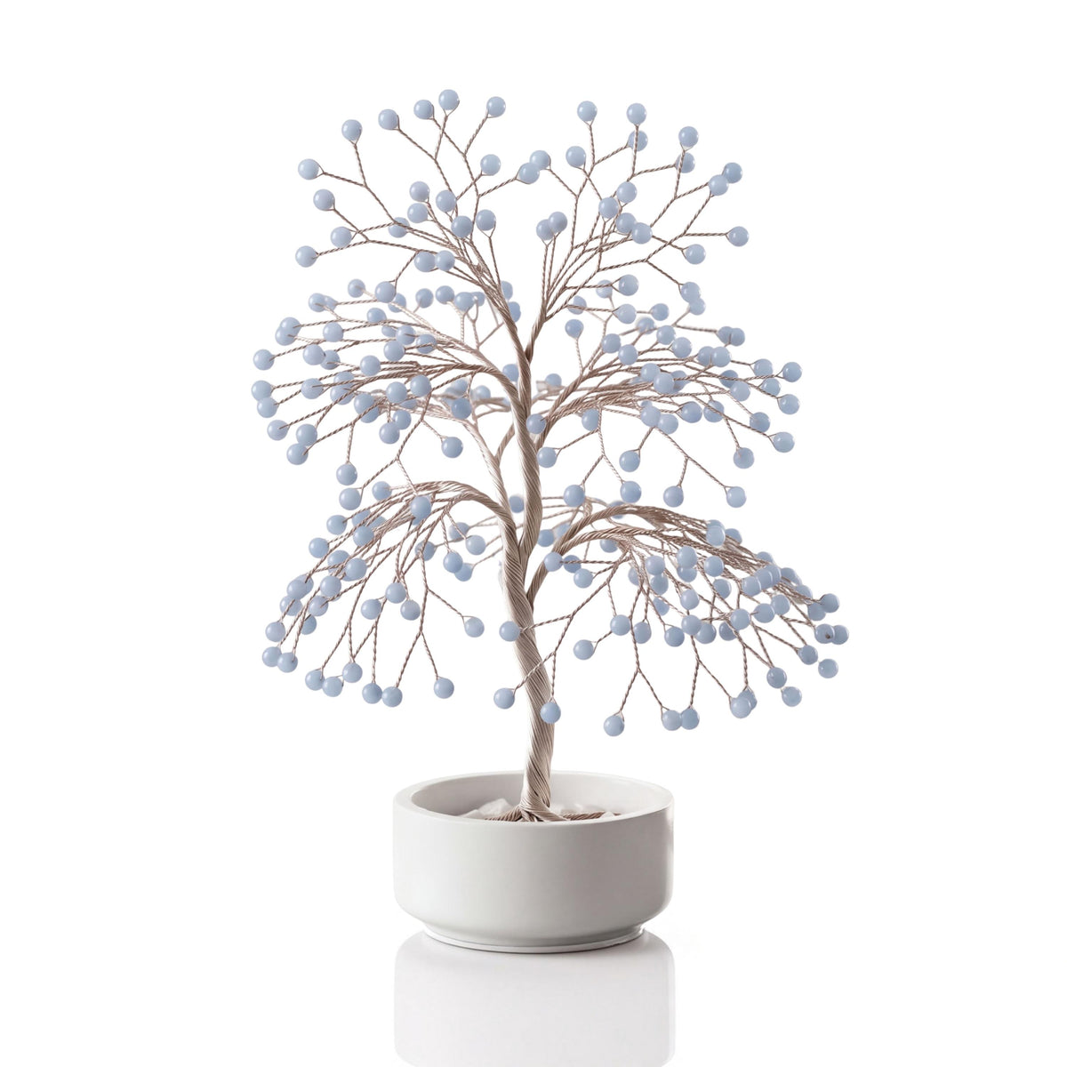 Silver-plated wire tree with polished pale sky blue angelite spheres in a white ceramic bowl