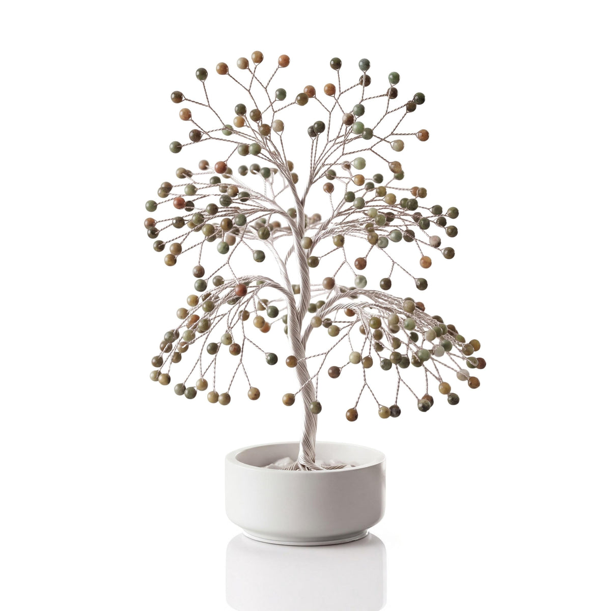 Silver-plated wire tree with polished olive and rust green opal spheres in a white ceramic bowl