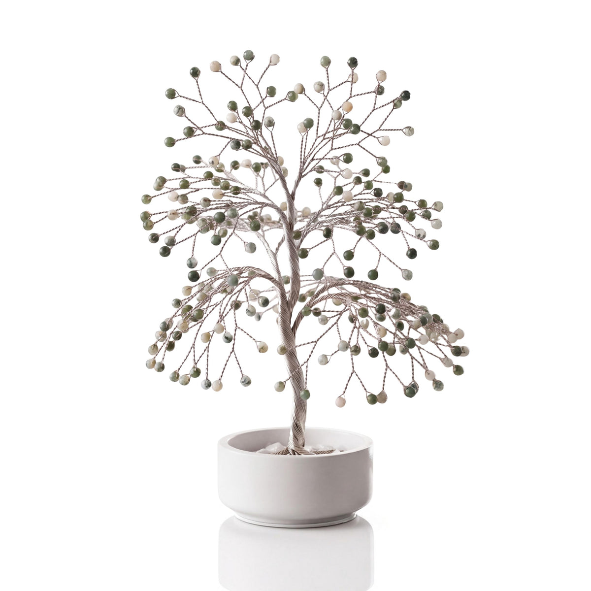 Silver-plated wire tree with polished white and green tree agate beads in a white ceramic bowl