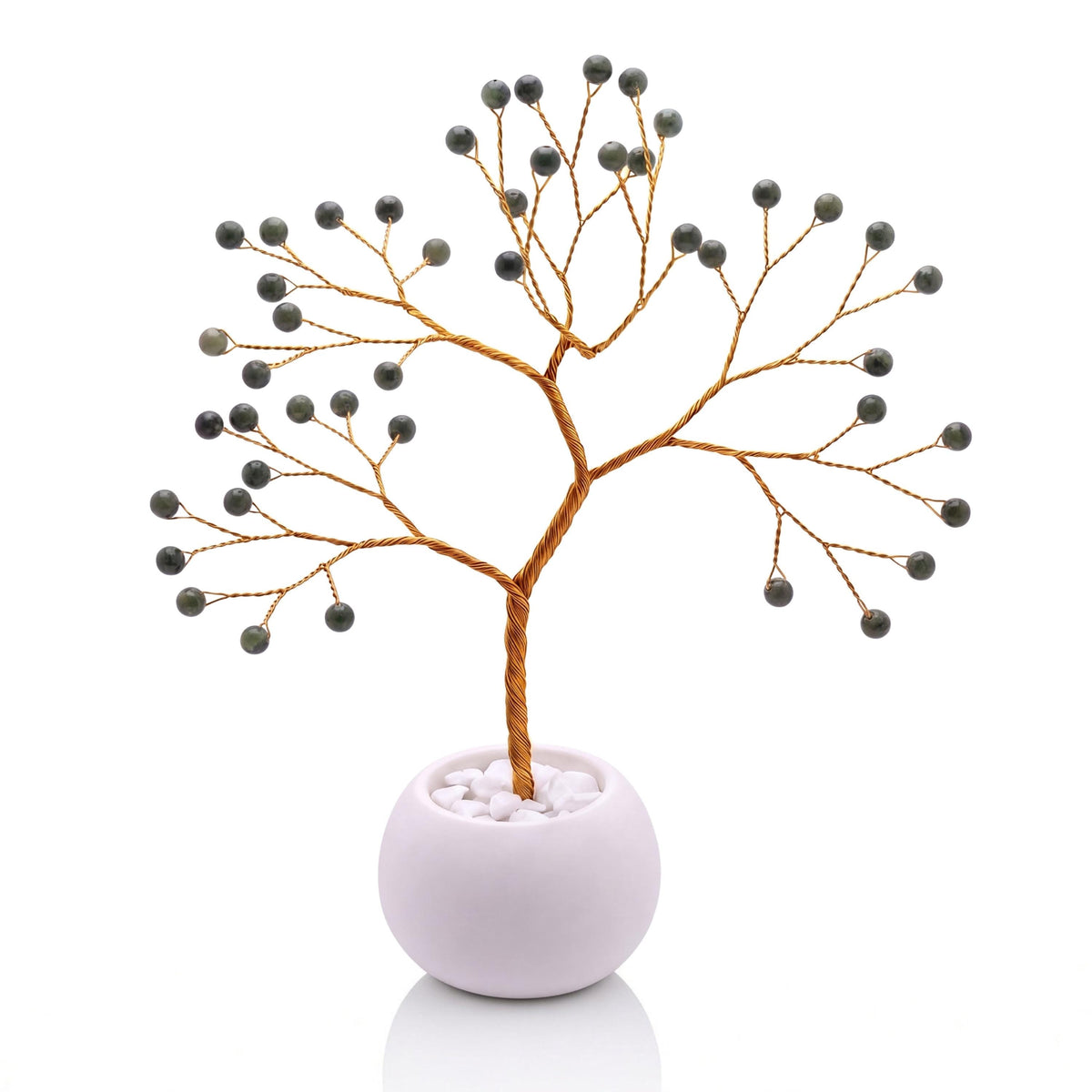 Gold-plated wire tree with polished spinach green nephrite jade beads in a white bowl with white pebbles