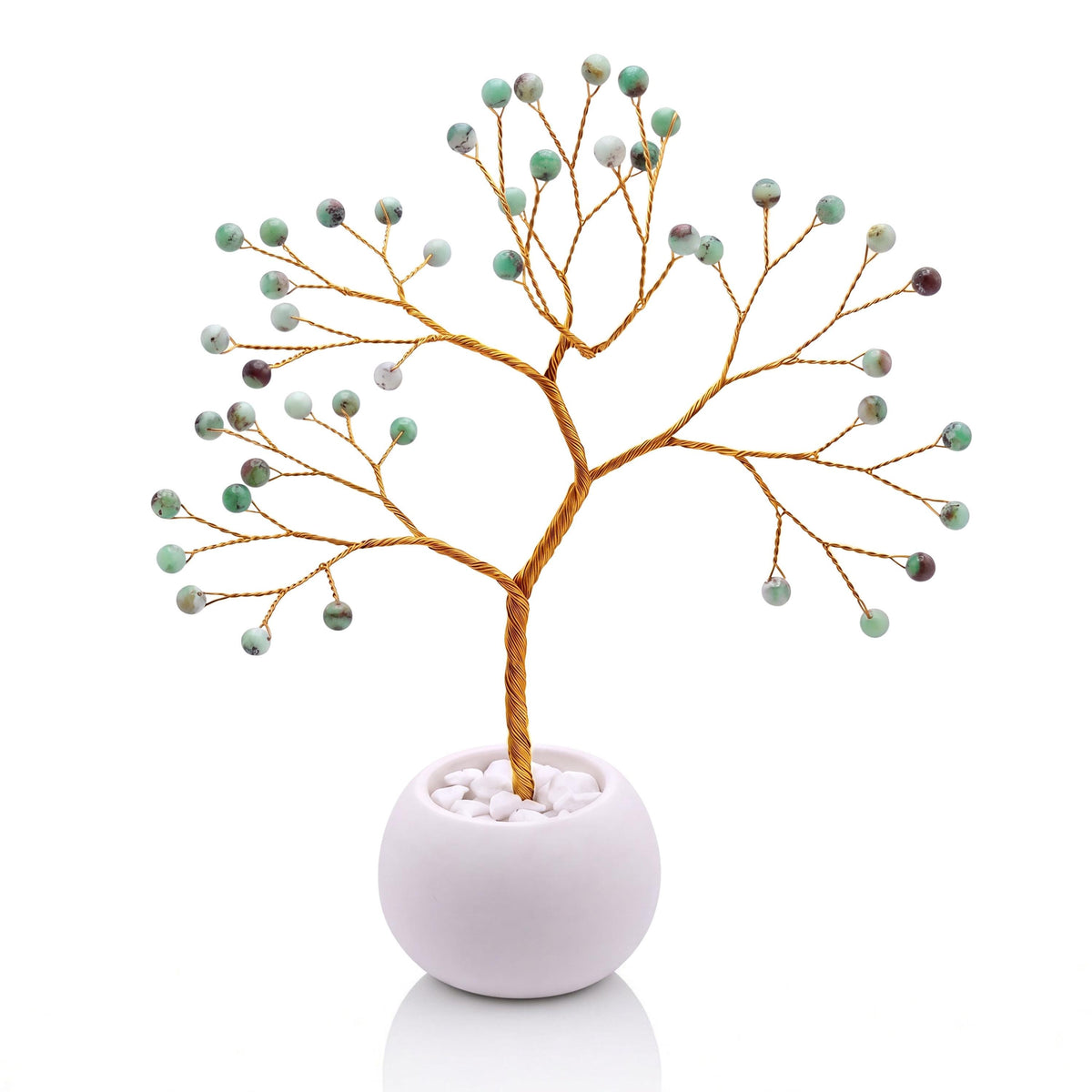 Gold-plated wire tree with polished apple green chrysoprase beads in a white bowl with white pebbles