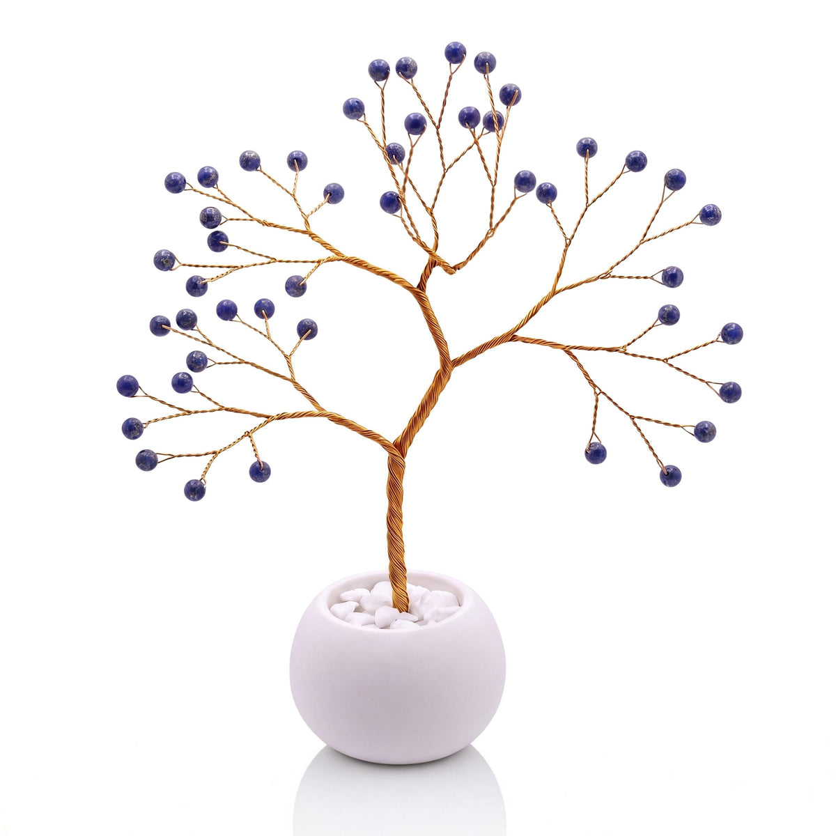 Gold-plated wire tree with polished deep blue lapis lazuli beads in a white bowl with white pebbles