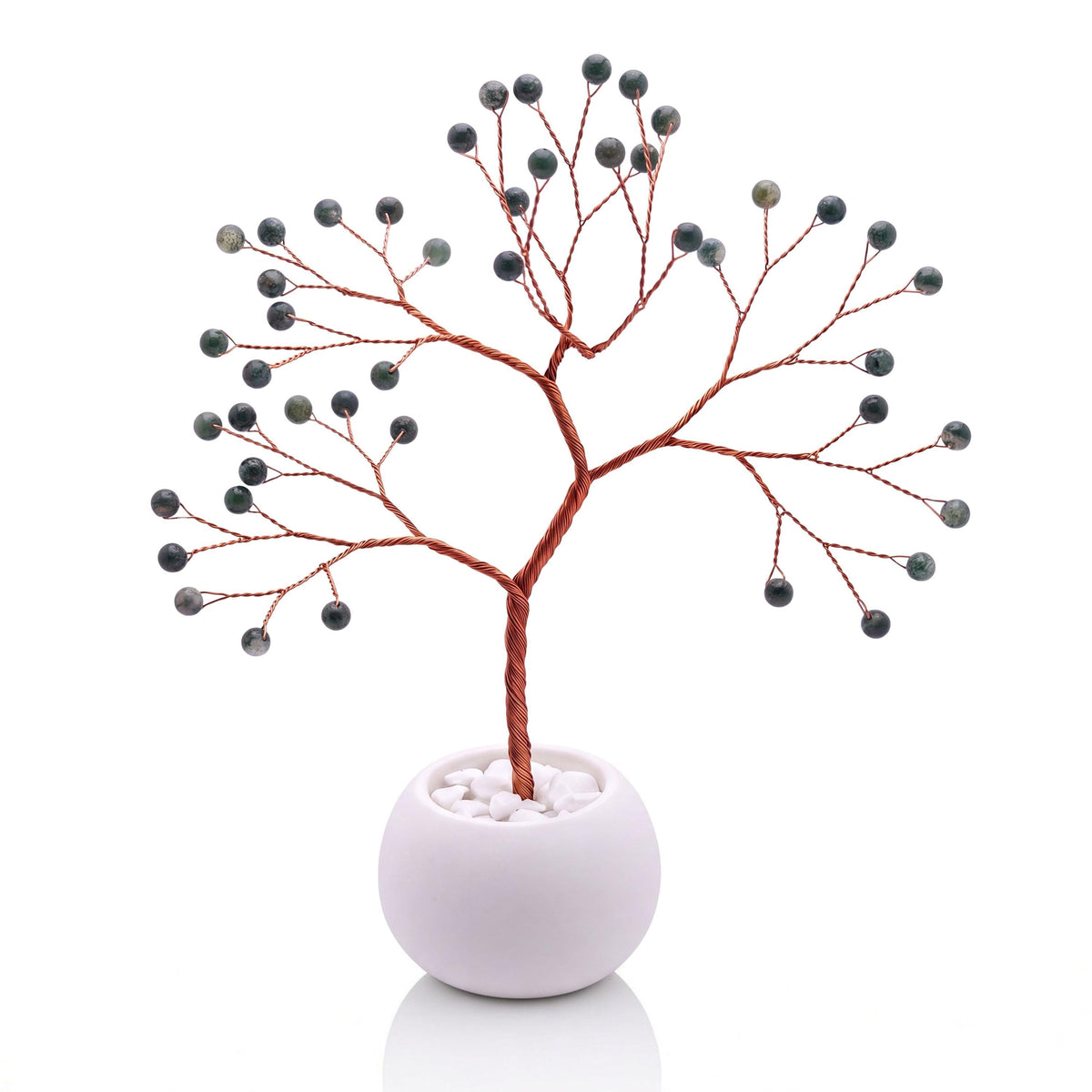 Copper wire tree with polished deep forest green moss agate beads in a plain white bowl filled with white pebbles