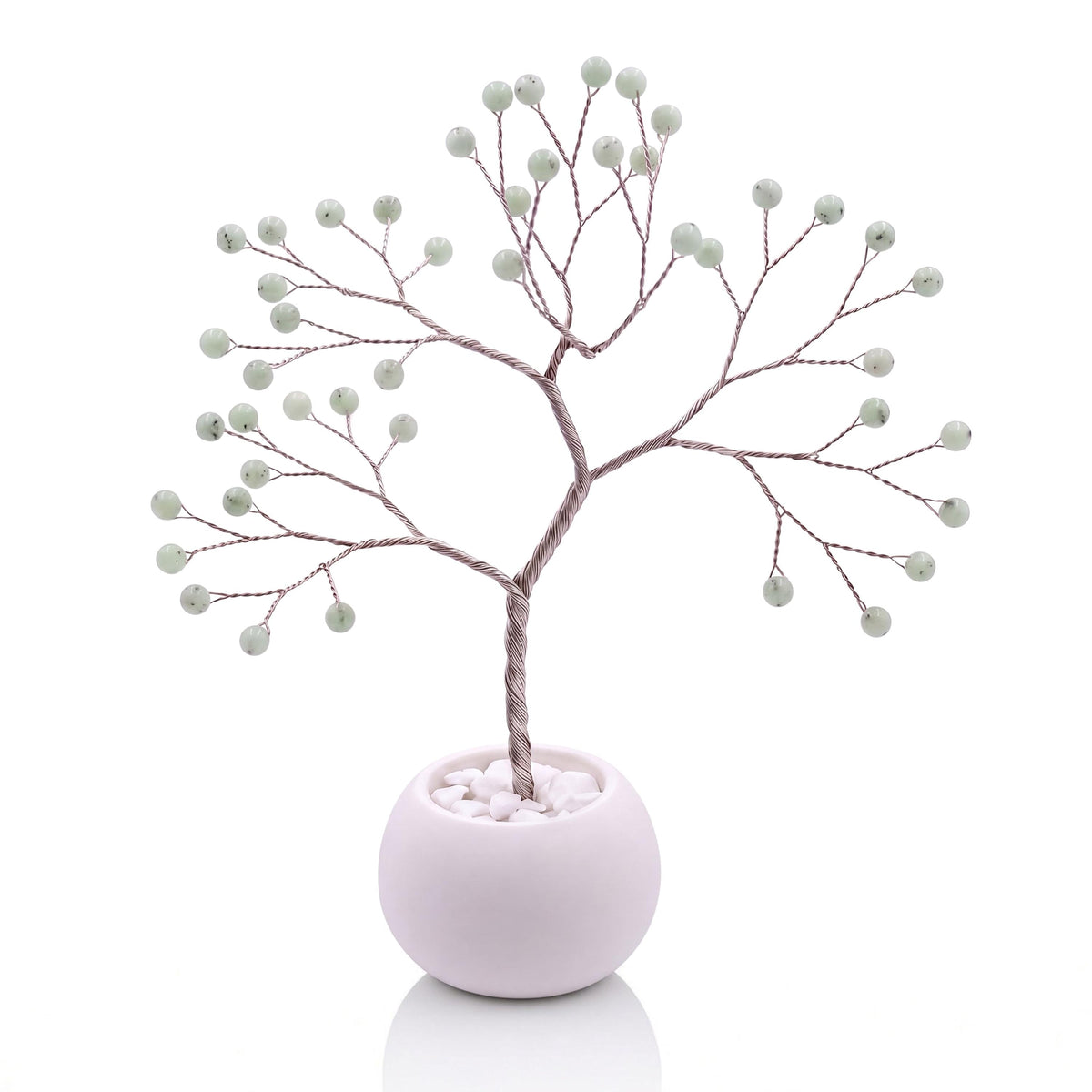 Silver-plated wire tree with polished celadon green hemimorphite beads in a white bowl with white pebbles