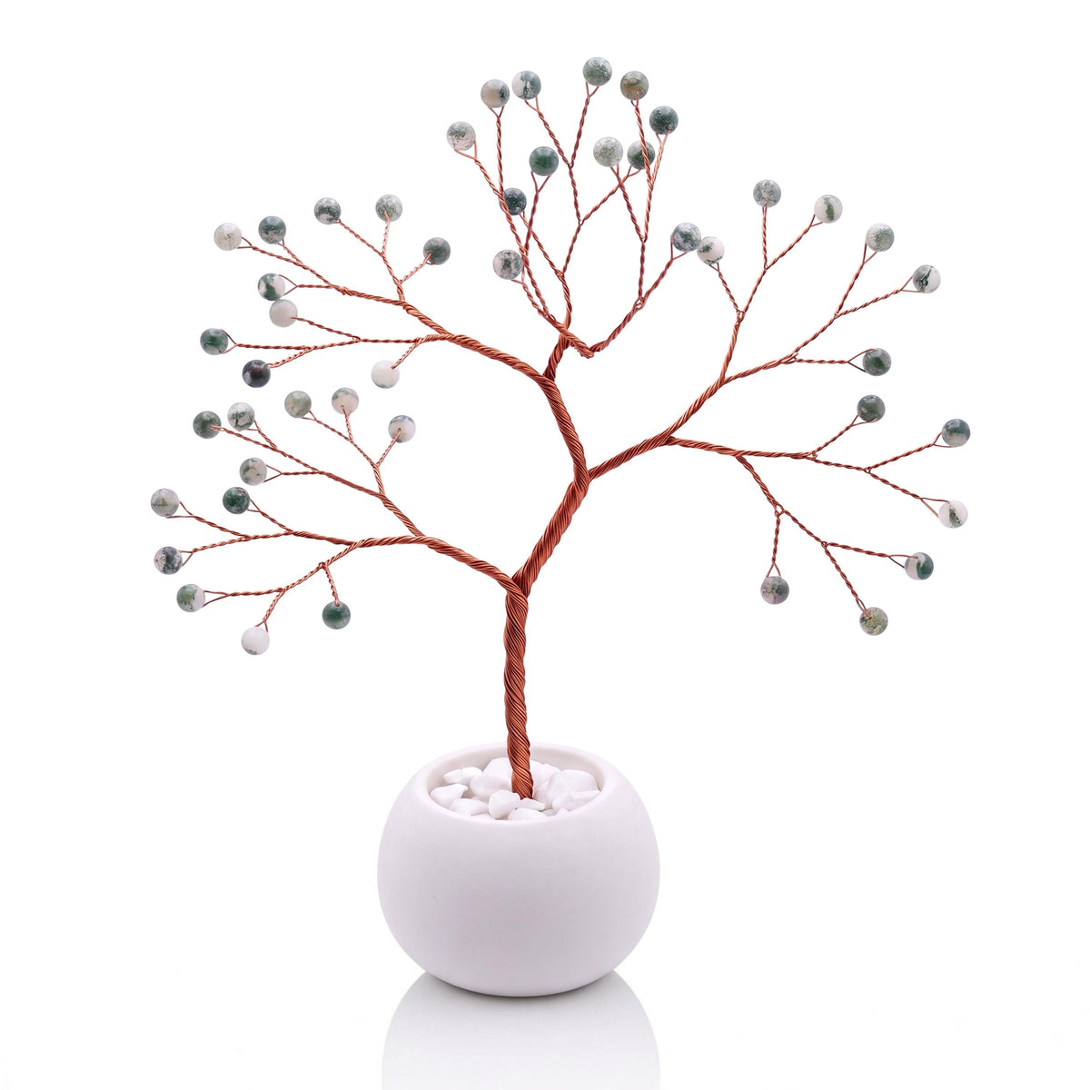 Copper wire tree with polished snowy white and fir green tree agate beads in a plain white bowl filled with white pebbles
