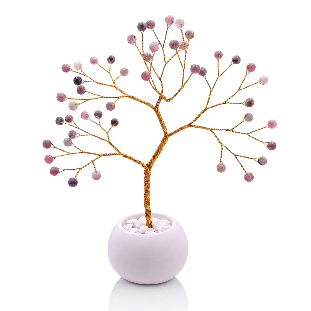 Gold-plated wire tree with polished lingonberry pink thulite beads in a white bowl with white pebbles