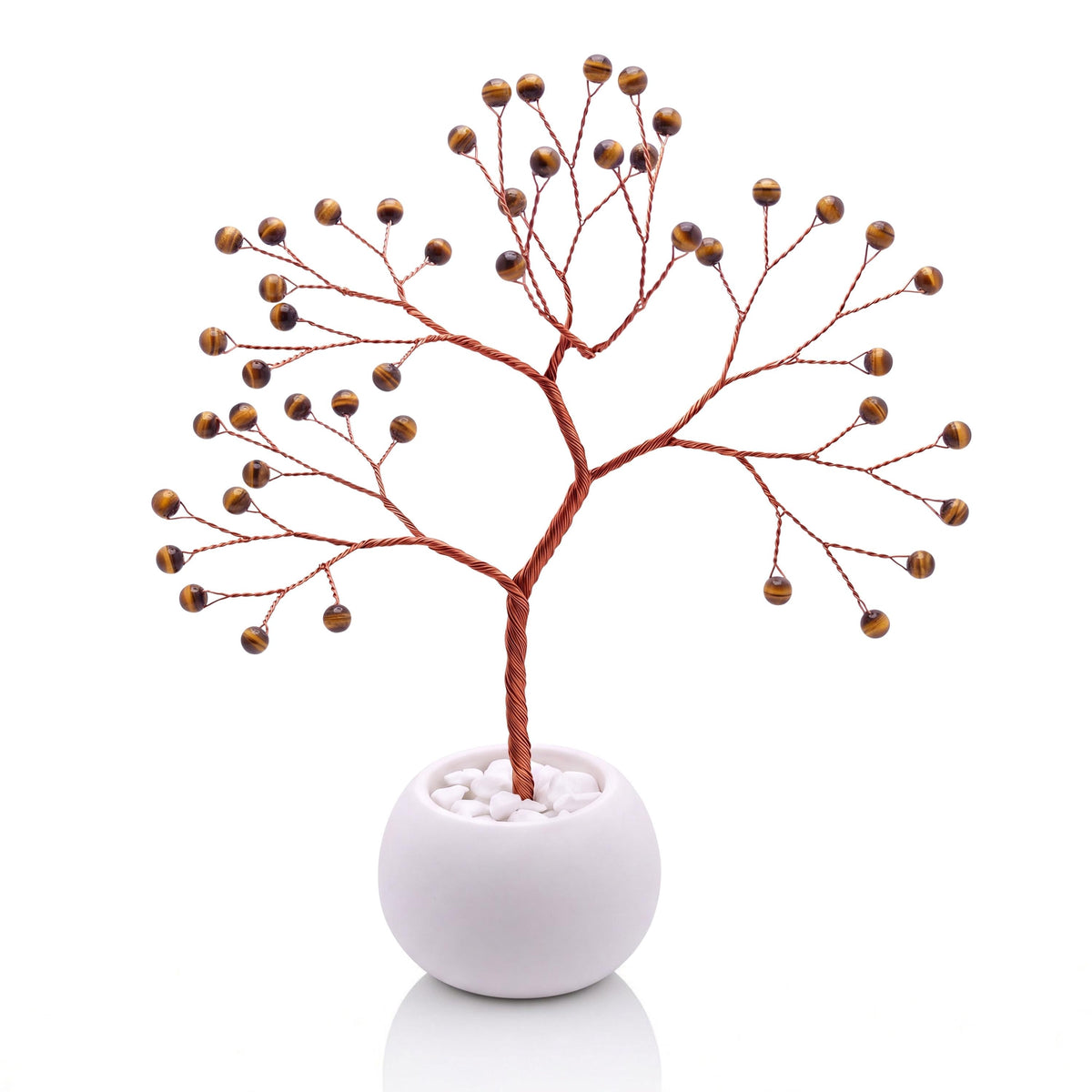 Copper wire tree with polished golden brown tiger's eye beads in a plain white bowl filled with white pebbles