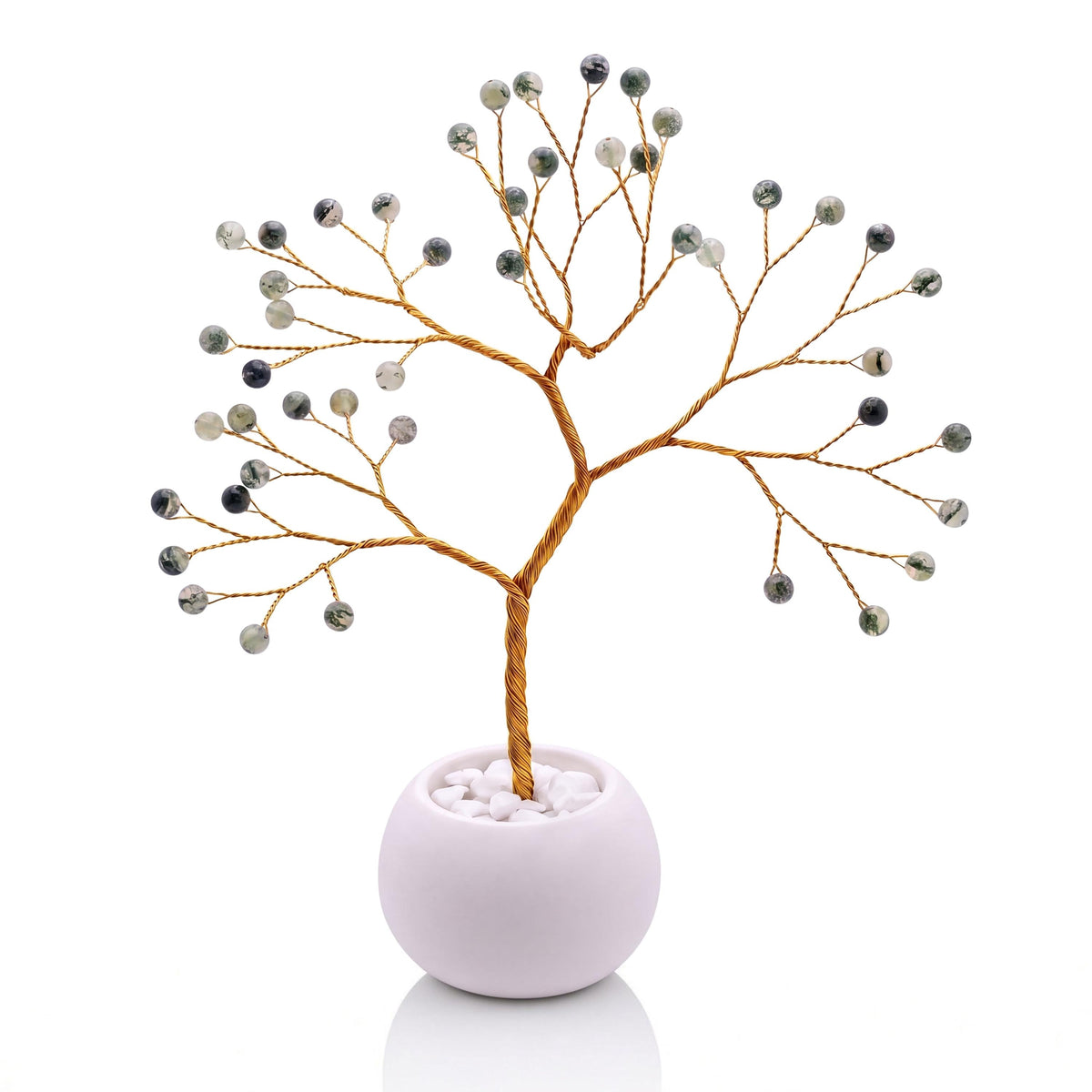 Gold-plated wire tree with polished green prehnite beads in a white bowl with white pebbles