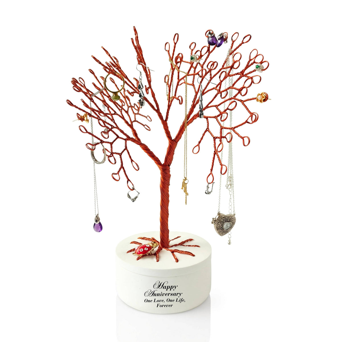 Copper wire jewelry tree in a white anniversary bowl with jewelry hanging on the branches