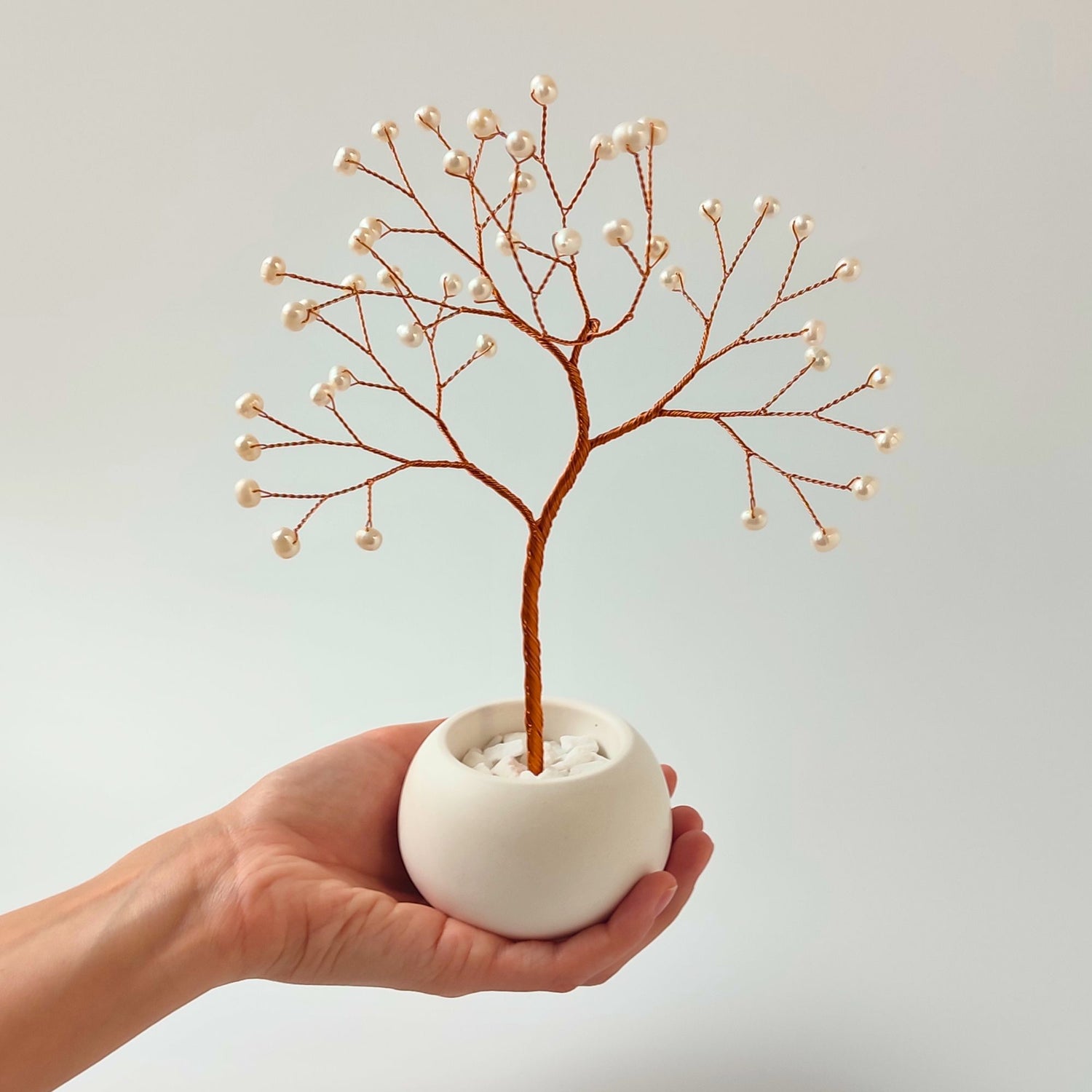 Size reference – pearl tree sculpture held in hand to show scale