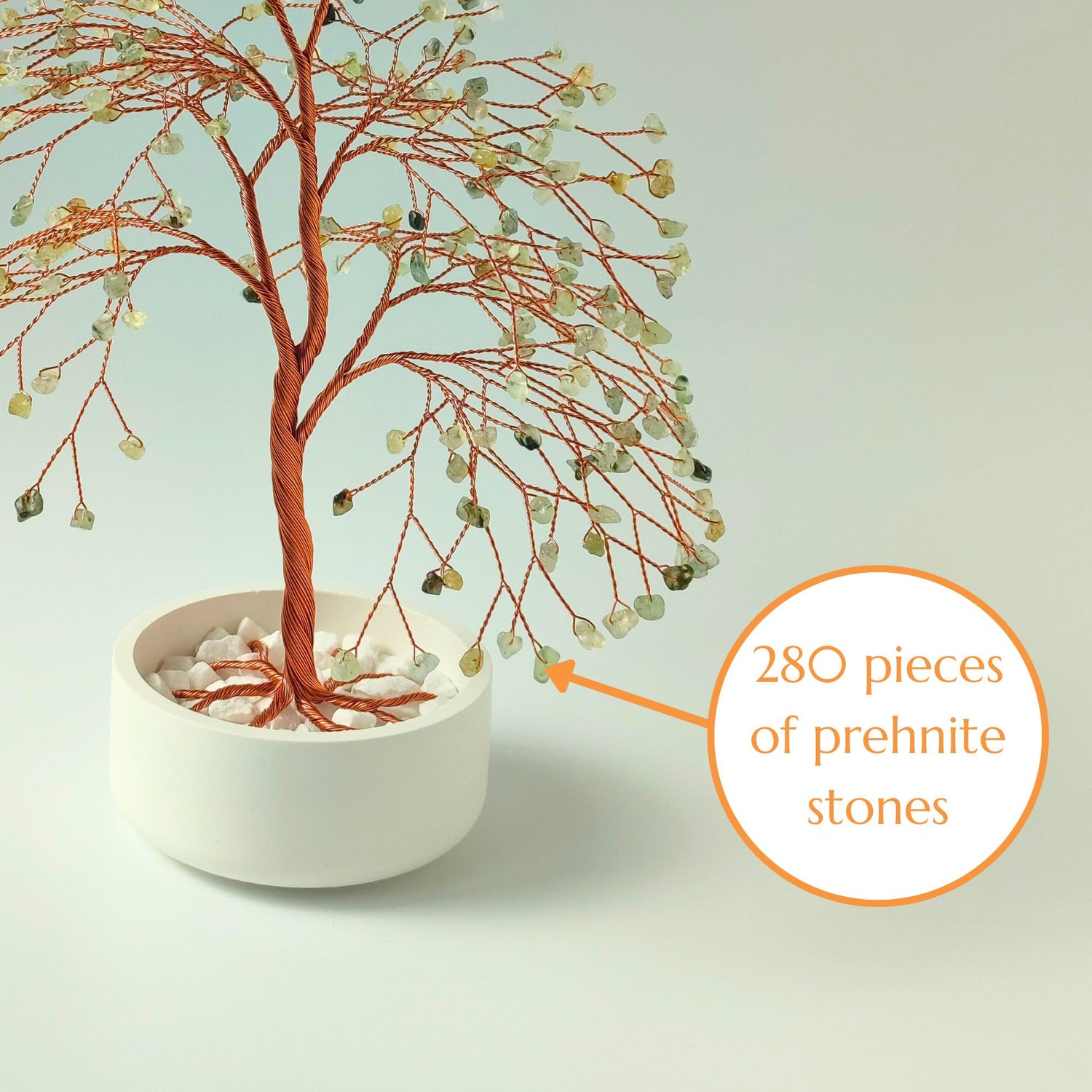 Close-up of copper wire branch with 280 natural prehnite gemstone – elegant detail