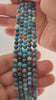Video of strands of teal blue apatite spheres used for this tree, held in the hand