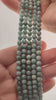 Video of strands of pale green Burmese jadeite beads used for this tree, held in the hand