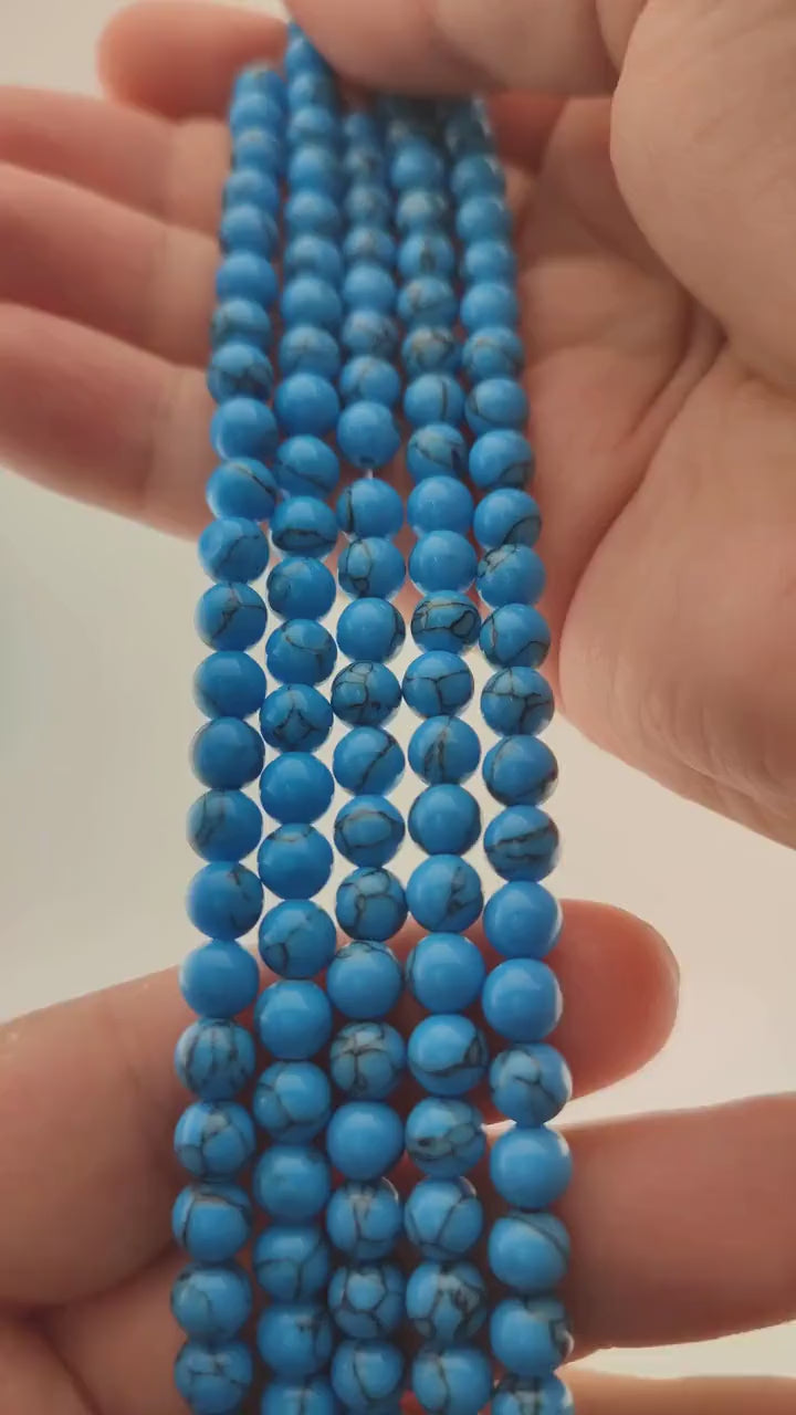 Video of strands of robin's egg blue howlite beads used for this tree, held in the hand