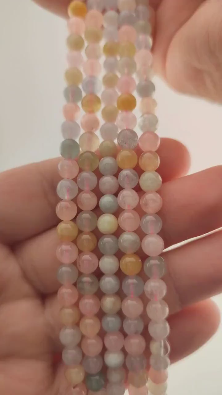 Video of strands of pastel morganite, heliodor and aquamarine spheres used for this tree, held in the hand
